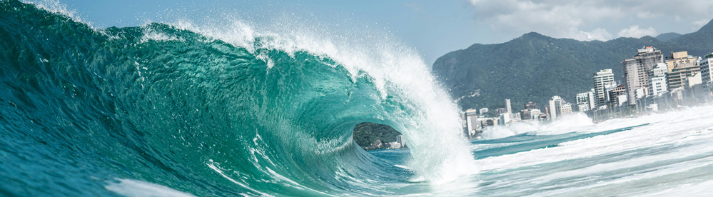 A wave crashes against the beach - In an NTP amplification attack, the attack load piles up like a wave.